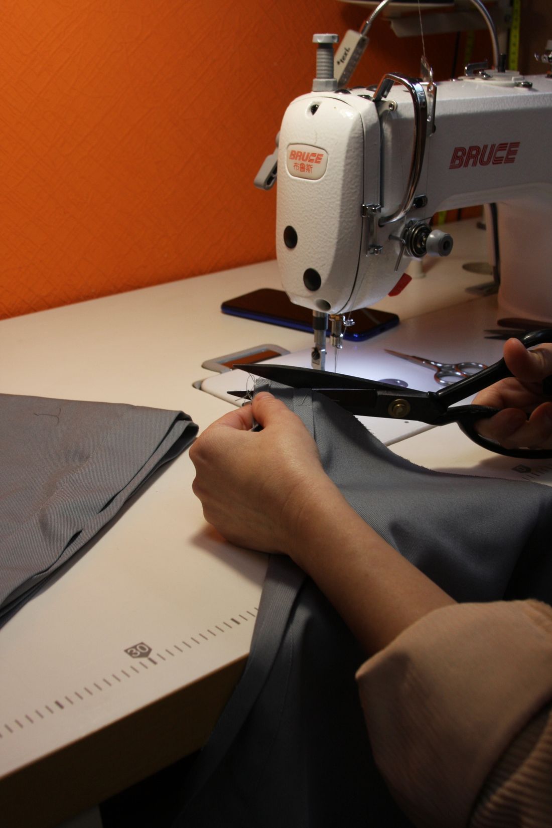 Machinist sewing a garment on the factory floor